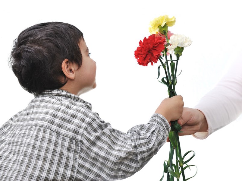 Give this flower. Kid giving Flowers to woman. Advantage of Flower delivery. Teacher hand Flower. Giving Gift teacher image.