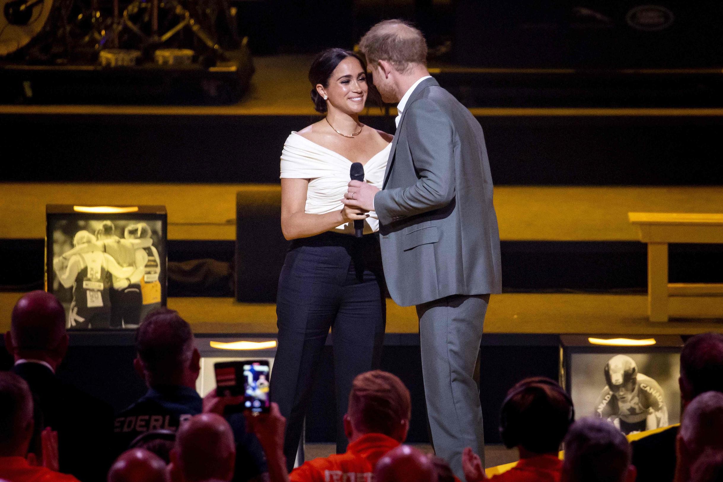 Harry and Meghan show their love for each other during the first day of Invictus Games in The Hague