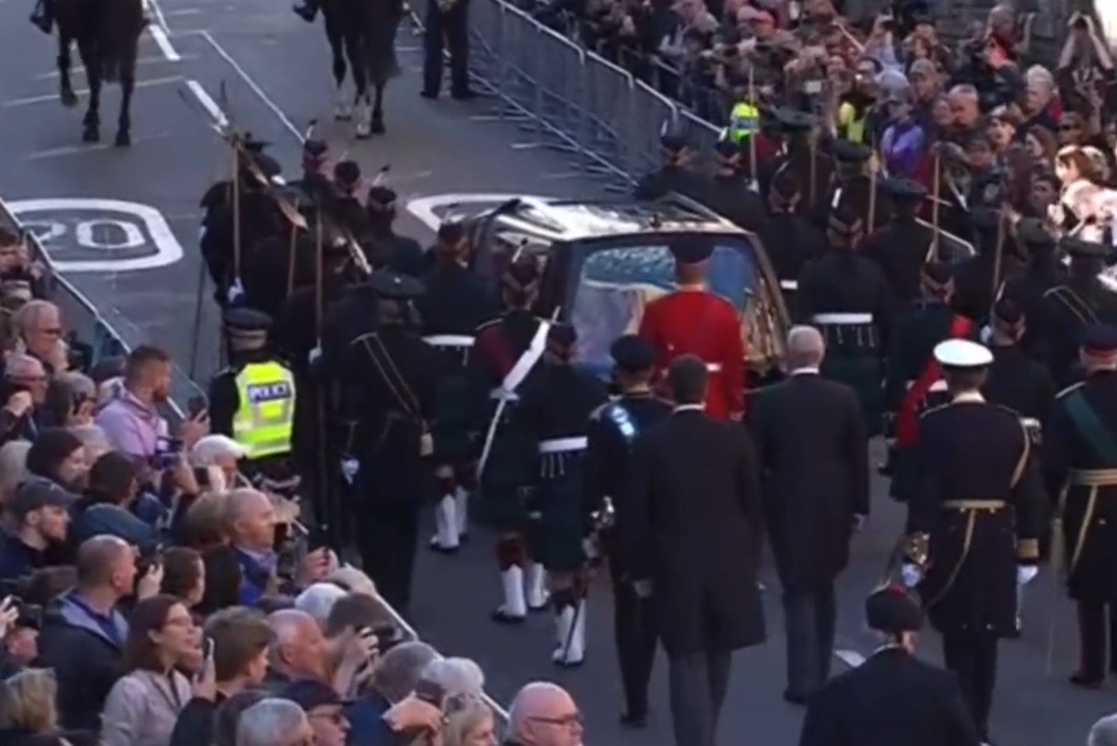 Police arrest a man for reprimanding Prince Andrew during the Royal Mile funeral procession