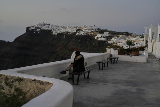 While thousands of people flee for earthquakes, some people enjoy a view of Santorini